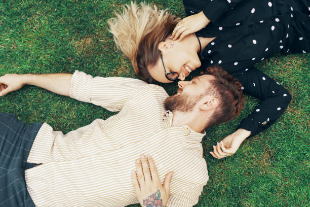 istock Couple in love lying on the grass 1203540074