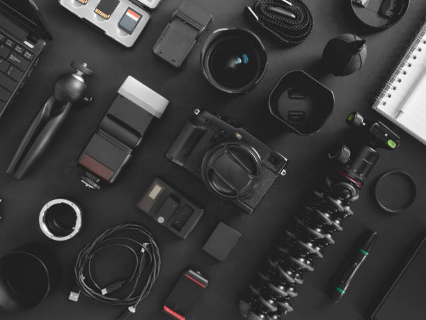 istock top view of work space photographer with digital camera, flash, cleaning kit, memory card, tripod and camera accessory on black table background 1203540759