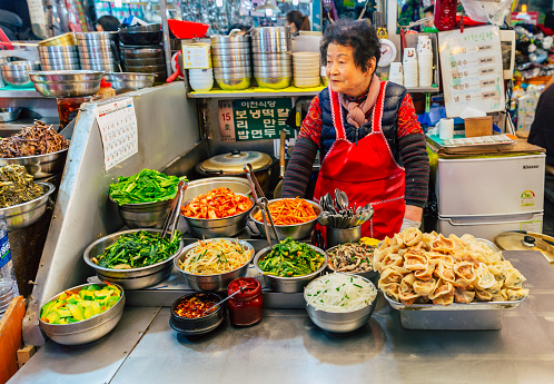 The pic shows The famous Gwangjang Market in Seoul, South Korea. Street food vendors selling korean street food. The pic is taken in november 2019 in seoul.