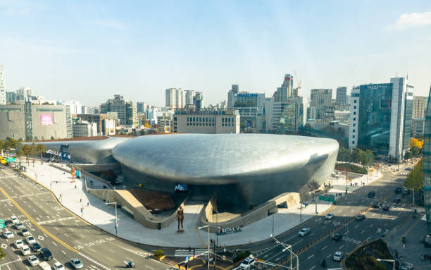 Aerial View of Dongdaemun Design Plaza in Seoul South Korea This pic shows Aerial View of Dongdaemun Design Plaza in Seoul South Korea. The pic is taken from high and traffic on the road can be seen along with design plaza. The pic is taken in day time and in november 2019 in seoul. aerial view of seoul south korea capital city stock pictures, royalty-free photos & images