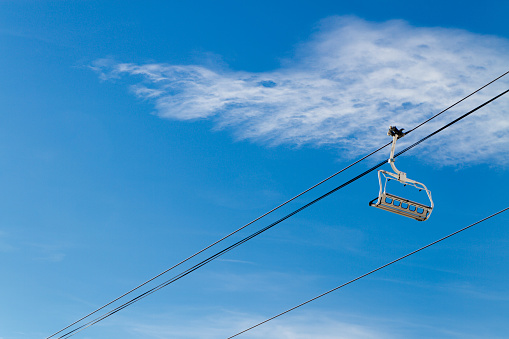 Ski lifts on background of blue sky with clouds