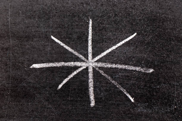 istock White chalk hand drawing in asterisk shape on black board background 1203546966
