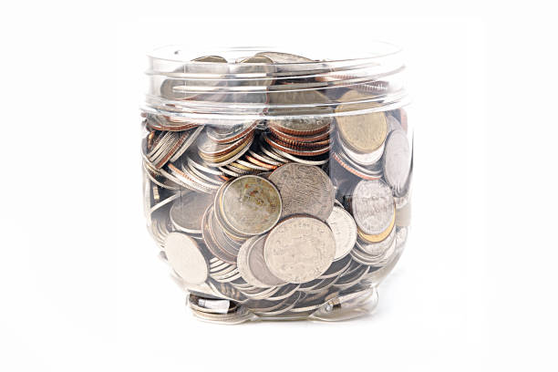 istock Coins in plastic bottle on white background 1203550584
