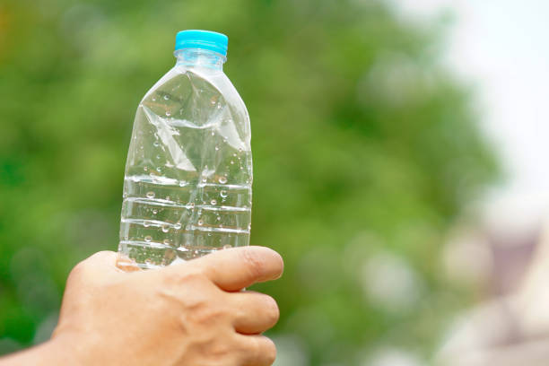 istock Hand squeeze empty water bottle prepare throw into the trash. 1203550800