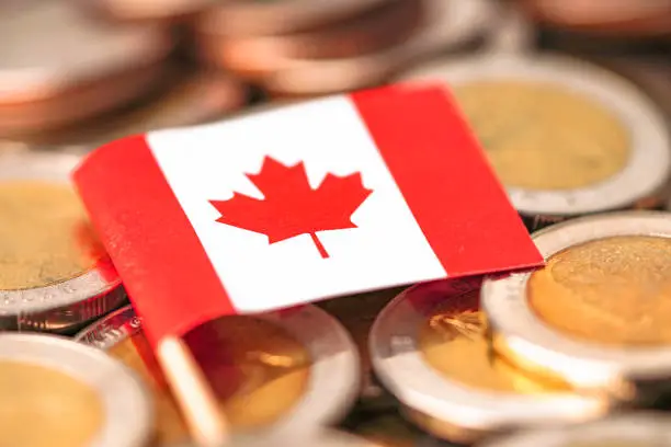 Photo of Canada Flag on coins background : Business and finance concept.