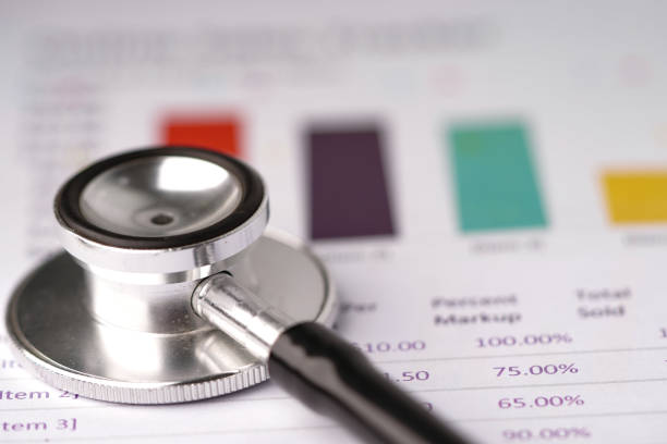 istock Stethoscope on chart or graph paper, Financial, account, statistics and business data  medical health concept. 1203552731