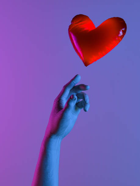 istock Human Hand Lightened With Blue And Pink Neon Lights Sending Red Heart Balloon. Proposal. Surprise. 3d rendering. 1203552856
