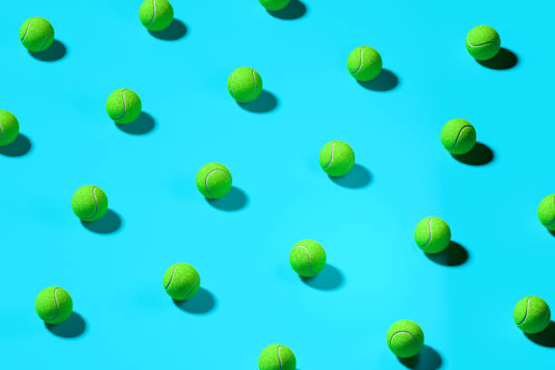 istock Green Baseball Balls Isolated On Blue Background. 3d Rendering 1203553904