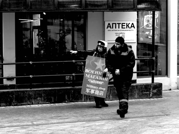 Moscow, Russia - February 01, 2020: a sandwichwoman is pointing a way to the construction worker on the street