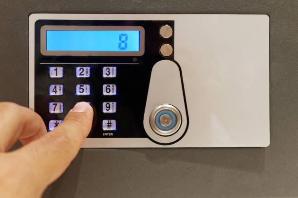 istock Closeup finger touching keypad of digital safe 1203557025