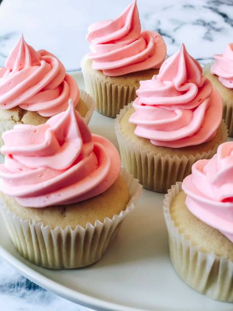 istock Gluten-free vanilla cupcakes with pink frosting 1203557896