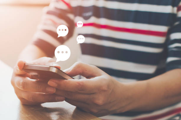 istock Close-up image of male hands typing text on mobile smartphone. Online live chat chatting on application communication digital media website and social network 1203558069