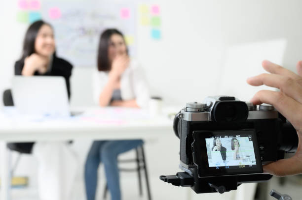 istock Behind the scene concept. Videographer working by camera recorder digital footage in workplace room 1203558251