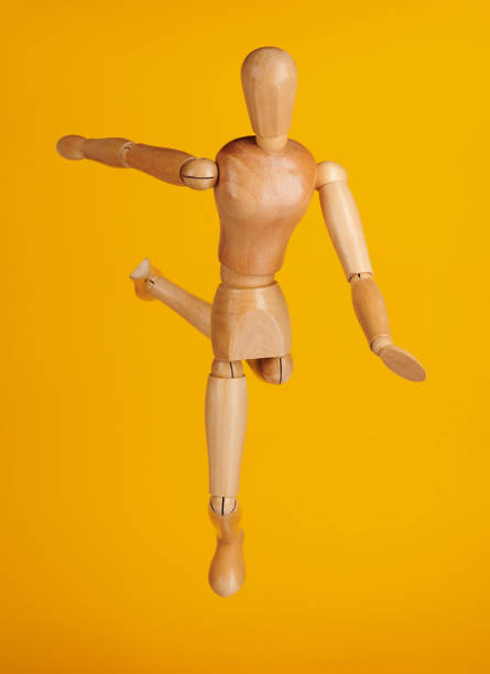 istock Wood figure in soccer pose 1203559961