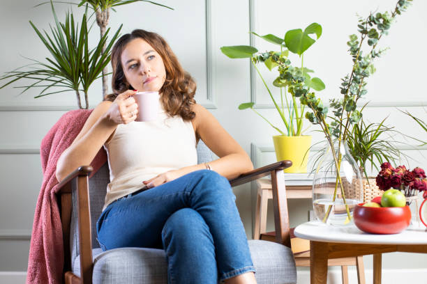 istock Young woman drinking a cup of coffee 1203560107