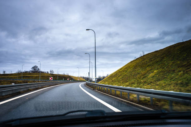 istock A road bend seen from a moving car through the windshield. 1203561801