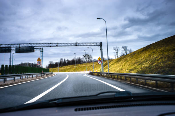 istock A road bend seen from a moving car through the windshield. 1203561802