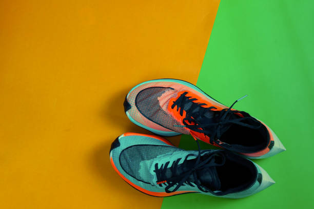 istock Blue and orange running shoe on green floor with copy test space,top 1203562693