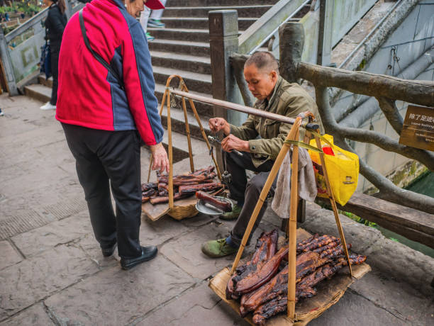 Unacquainted Chinese local people Selling Larou of smoked pork in  fenghuang old town .phoenix ancient town or Fenghuang County is a county of Hunan Province, China fenghuang,Hunan/China-16 October 2018:Unacquainted Chinese local people Selling Larou of smoked pork in  fenghuang old town .phoenix ancient town or Fenghuang County is a county of Hunan Province, China fenghuang county photos stock pictures, royalty-free photos & images