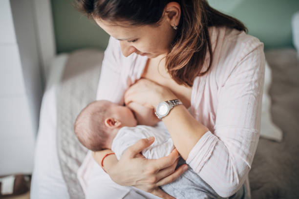 istock Mother breastfeeding baby boy 1203570642