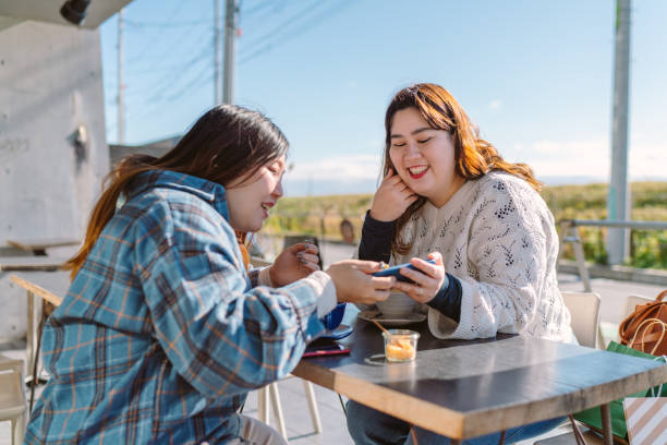 istock Two young friends having good time in cafe 1203570844