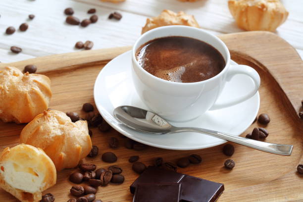istock Profiteroles with coffee and chocolate on a white background 1203570846