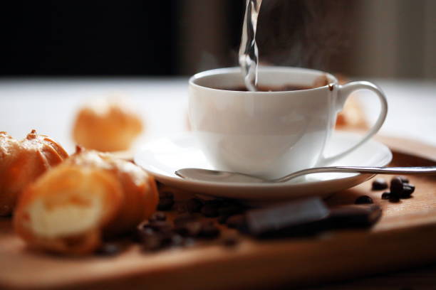 istock Profiteroles with coffee and chocolate on a white background 1203570849