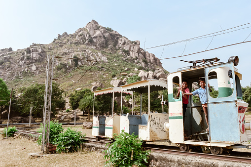 Khandoli Park, Giridih, Jharkhand, India May 2018 - Kids enjoying an Amusement Park Toy Train ride while nicely posing to the photographer. Kid Poses For Photography at a Toy Train..