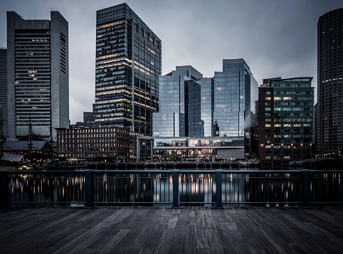 View of downtown Boston and the financial district from across Boston Harbor - desaturated long exposure photo at dusk