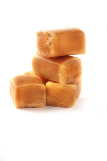istock Caramel bonbons isolated on white background. 1203571823