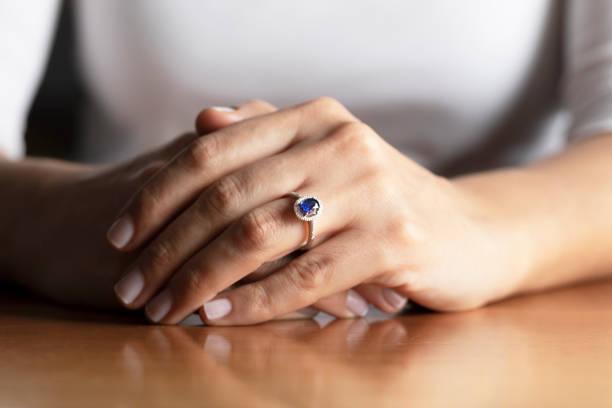 Sapphire Ring Close up of womans hand wearing a sapphire ring. sapphire stock pictures, royalty-free photos & images