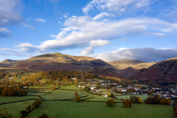 istock Stunning aerial drone landscape image from in the clouds looking down on hills and valleys on a vibrant Autumn Fall morning 1203573091