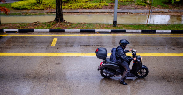 Singapore-29 JAN 2020:Motorcycle driver on the road after rain
