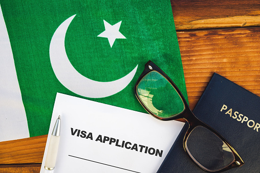 Flag of Pakistan, visa application form and passport on table