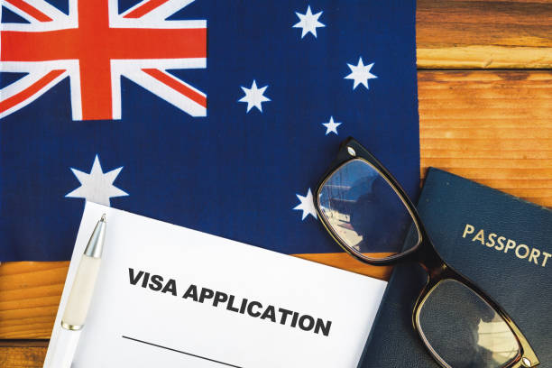 Australia visa application Flag of Australia , visa application form and passport on table embassy photos stock pictures, royalty-free photos & images