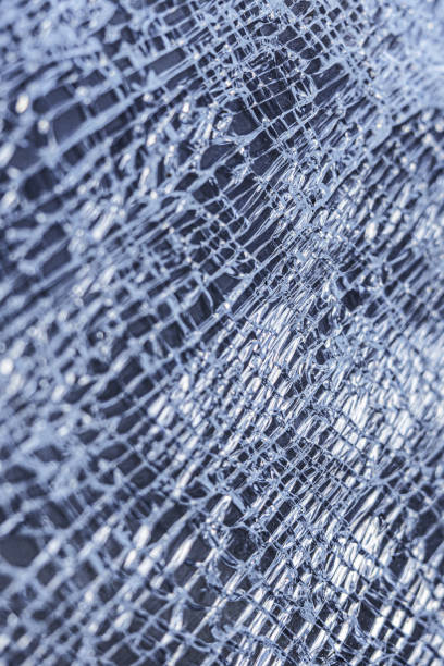 istock broken glass background. a glass window cracked with cobwebs. abstraction 1203577396