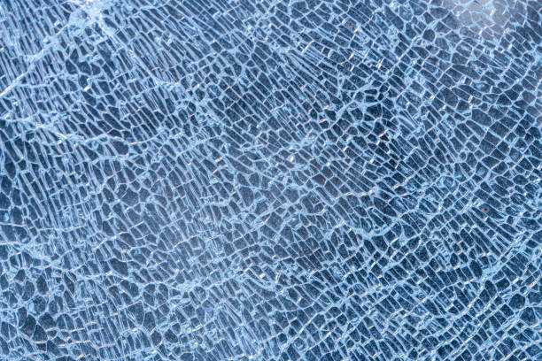 istock broken glass background. a glass window cracked with cobwebs. abstraction 1203577498