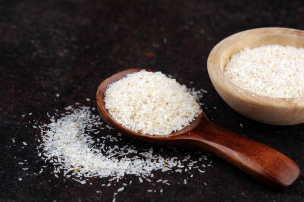 istock Portion of Psyllium Seeds on rustic dark background. Psyllium seed husks on wood 1203579443