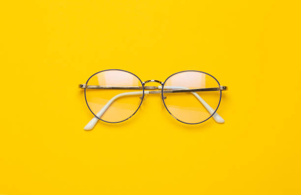 istock Eye glasses isolated on yellow background 1203580600