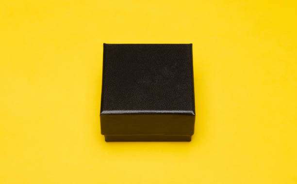 istock Mini black box product packaging isolated on yellow background 1203580658