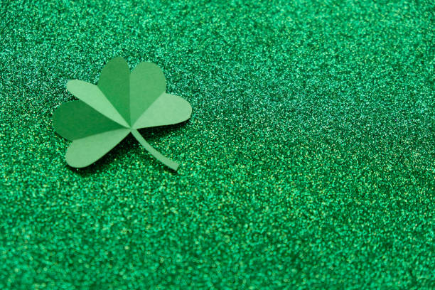 istock St. Patrick's day, clover on a green shiny background 1203580745