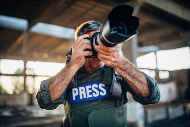 istock Journalist making reportage from the war zone 1203582520