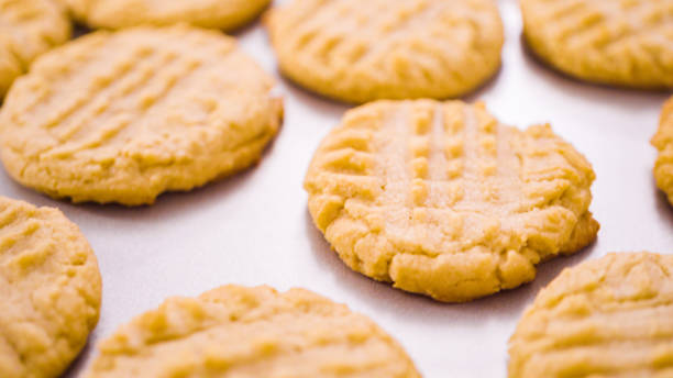 istock Freshly baked peanut butter cookies on baking sheet. 1203586688