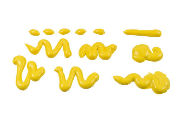istock Yellow cheese sauce splashes isolated on white background. 1203586732