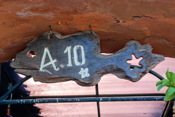 istock House number 10  in the shape of a fish. 1203586845