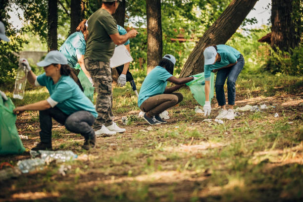istock Volunteers cleaning garbage together in park 1203587931