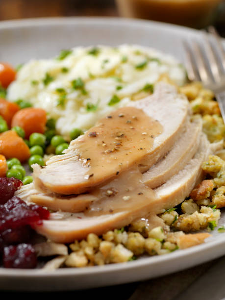istock Roast Turkey Dinner With Stuffing,Mashed Potatoes, Cranberry Sauce, Peas, Carrots and Gravy 1203590695