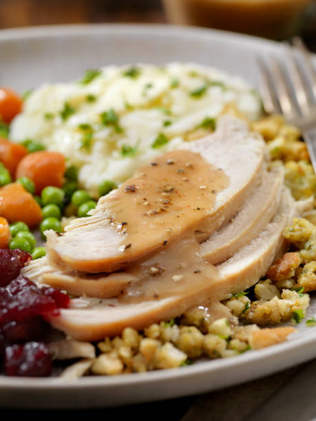 Roast Turkey Dinner With Stuffing,Mashed Potatoes, Cranberry Sauce, Peas, Carrots and Gravy The Hungry Man's Roast Turkey Dinner With Stuffing,Mashed Potatoes, Cranberry Sauce, Peas, Carrots and Gravy sauces table turkey christmas stock pictures, royalty-free photos & images