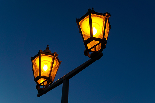 A vintage street lamp with orange light