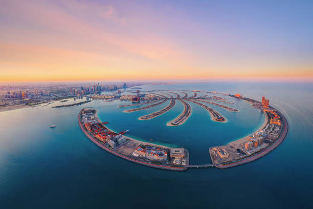 Aerial view of The Palm Jumeirah Island, Dubai Downtown skyline, United Arab Emirates or UAE. Financial district and business area in smart urban city. Skyscraper and high-rise buildings at sunset. stock photo